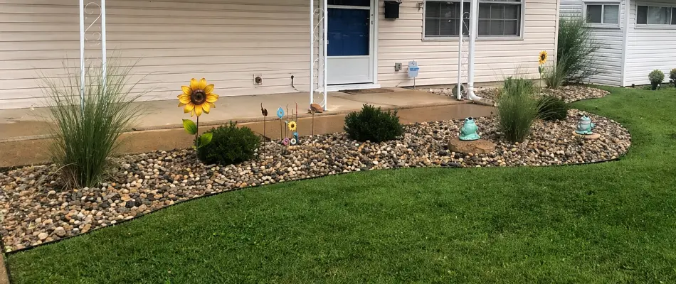 Rock landscape in St. Louis, MO, with plants and décor.